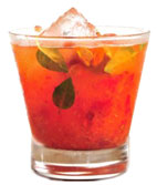 Basil Acerola Caipirinha - The Basil Acerola Caipirinha drink is made from Leblon Cachaca, acerola, basil and sugar, and served in an old-fashioned glass.